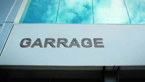 Garrage Sign on Modern Building with Cloud Reflection on Windows Glass Stock Footage 303559110