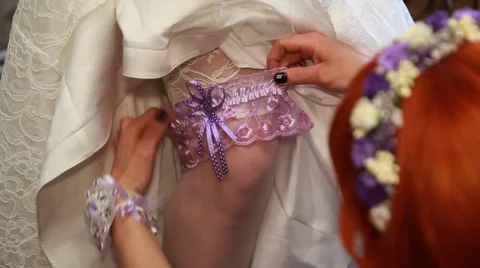 Garter on the leg of a bride Stock Footage 49734960
