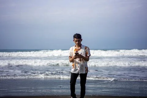 Garut, West Java – 2024, May 22: asian young man is taking photos using a phone Stock Photos