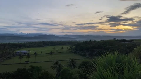 Garut West Java, May 12, 2025 A stunning view of the sunrise over the vast green Stock Footage 309908986