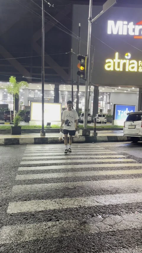 Garut, West Java, May 25 2025, a teenage boy was crossing the Sudirman highway r Stock Footage 310183073