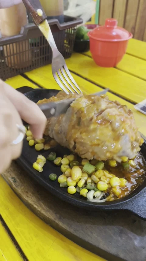 Garut, West Java, May 26, 2025, jumbo-sized meatballs are eaten and then served. Stock Footage 310182797