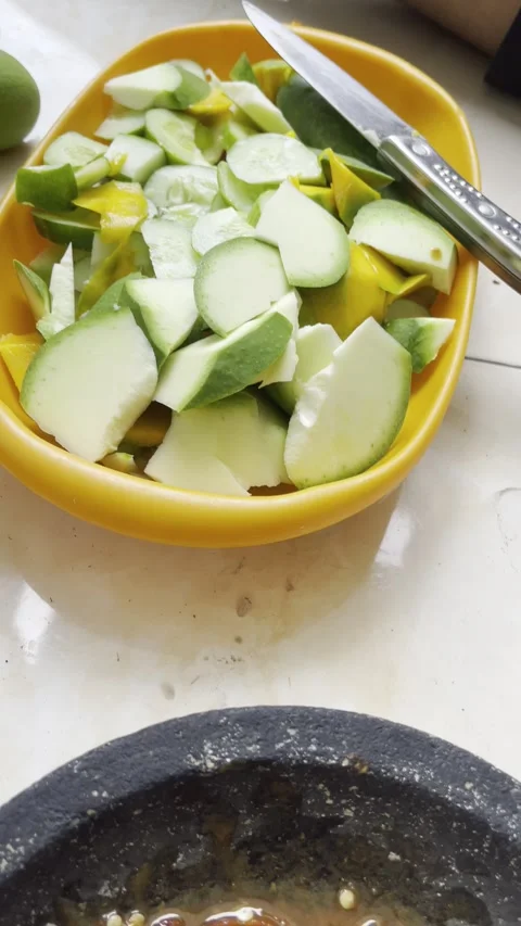 Garut, West Java, May 5, 2025, making rujak petis with various types of fruit wi Stock Footage 310182476