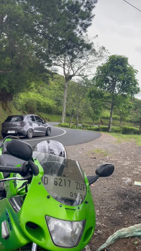 Garut, West Java, September 8, 2025, riding a Kawasaki Ninja 150 motorbike on th Stock Footage 324178612