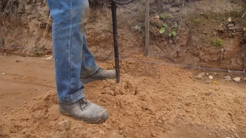 Gas auger in action, operator drills soil efficiently, worker operates Stock Footage 319690554