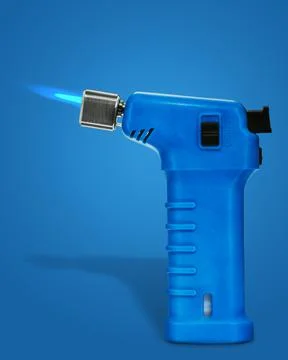 A gas blow torch kitchen with blue flame on the blue background 写真素材