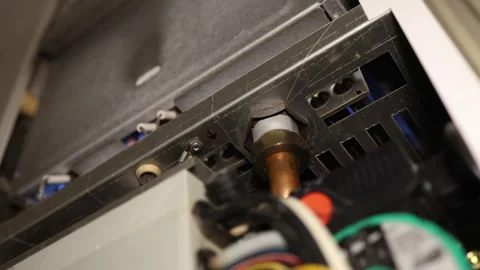 Gas boiler burner ignites to begin heating the home during cold weather Stock Footage 344055531