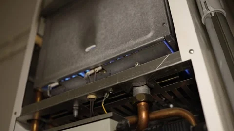 Gas boiler flashes and ignites as the heating season begins in a home Stock Footage 344055448