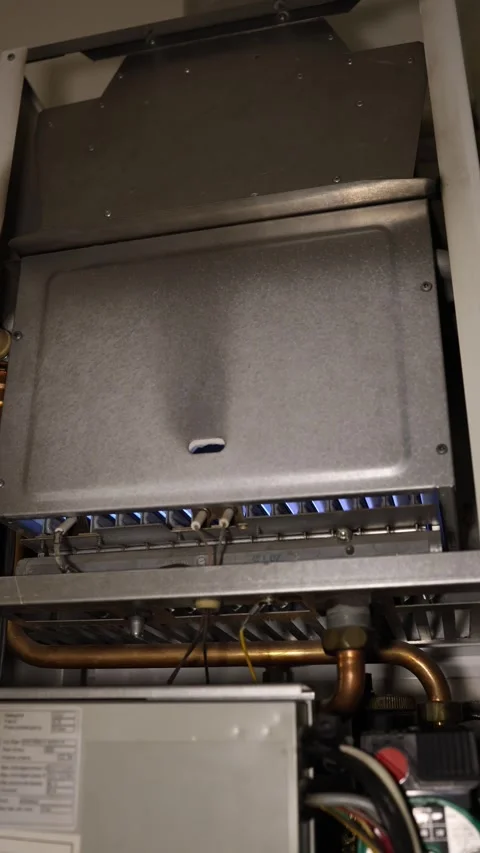 Gas boiler ignites with blue flame as the home heating season begins Stock Footage 344054844