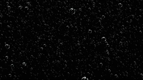 Gas bubbles float from the depth of the dark screen, increasing in size. Stock Footage 125164616