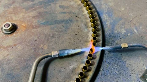 Gas Burner Flame Heating Brass Bullet Casings During Production Line Stock Footage 336650845