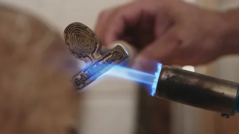 A gas burner heating the stamp for marking and branding wood. Stock Footage 205943394