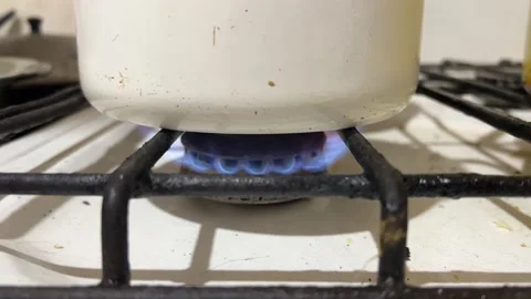 Gas burns on dirty old Soviet stove. Boiling water Stock Footage 229575282