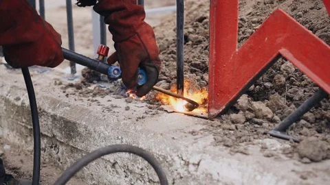 Gas cutter in the hands of a worker. A man cuts metal. Work on the construction. Stock Footage 128016686