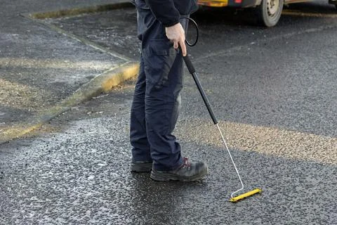 Gas Engineer Wearing PPE Using Long Handle Combustible Gas Leak Detector Photos