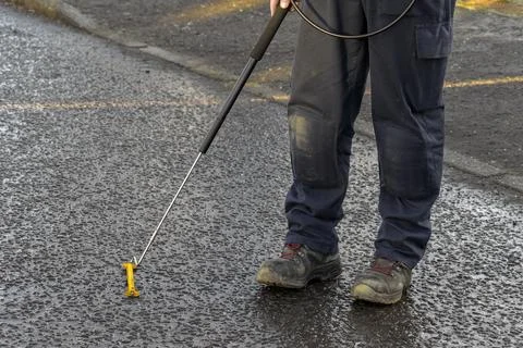 Gas Engineer Wearing PPE Using Long Handle Combustible Gas Leak Detector Stock Photos