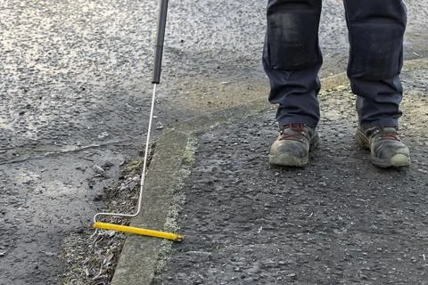Gas Engineer Wearing PPE Using Long Handle Combustible Gas Leak Detector Stock Photos