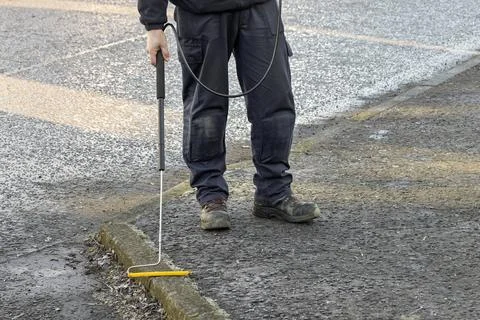 Gas Engineer Wearing PPE Using Long Handle Combustible Gas Leak Detector Photos