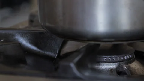 Gas fire being lit under cooking pot Stock Footage 138028765