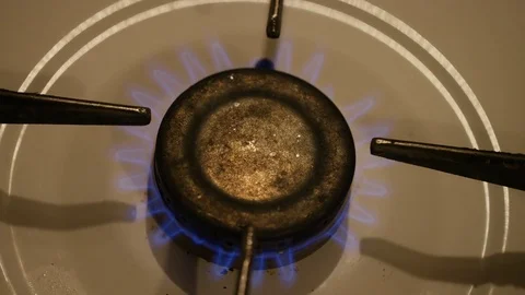 Gas fire light of a stove turning on Stock Footage