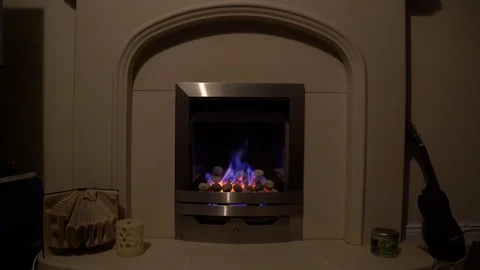 Gas fire with ukelele next to it straight on Stock-Footage 85534536