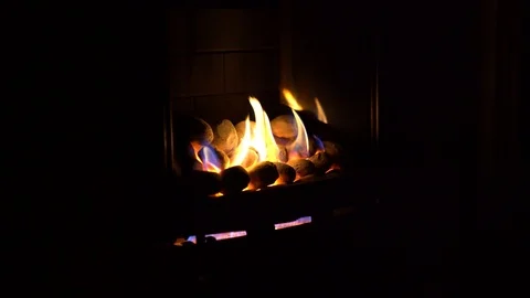 Gas fire with yellow flames in a dark room Stock Footage 85667202