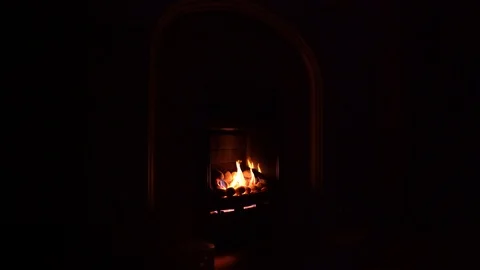 Gas fire with yellow flames in a dark room Stock Footage 85667378