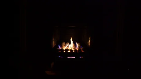 Gas fire with yellow flames in a dark room Stock Footage 85667500