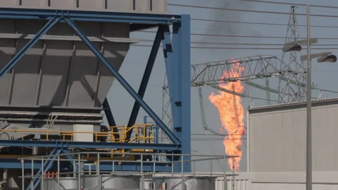 Gas flare behind structures, LS MS, Khormala oil field, Iraq Stock Footage 300111412