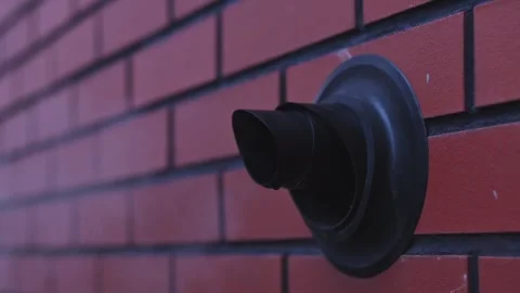 Gas heating exhaust pipe mounted on brick wall, representing home heating, .. Stock Footage 343354697