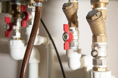 Gas heating system with red taps. Stock Photos