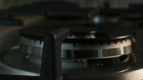 The gas is ignited by a blue flame in the kitchen on a large wok burner. Taken Stock Footage 131395759
