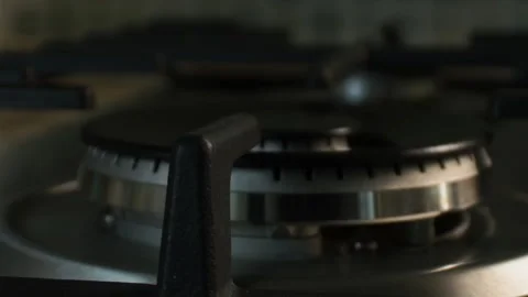 The gas is ignited by a blue flame in the kitchen on a large wok burner. Taken Stock Footage 131395768