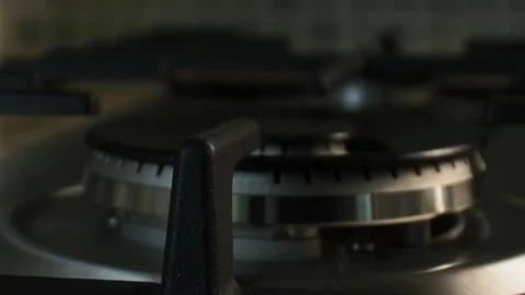 The gas is ignited by a blue flame in the kitchen on a large wok burner. Taken Stock Footage 131396035