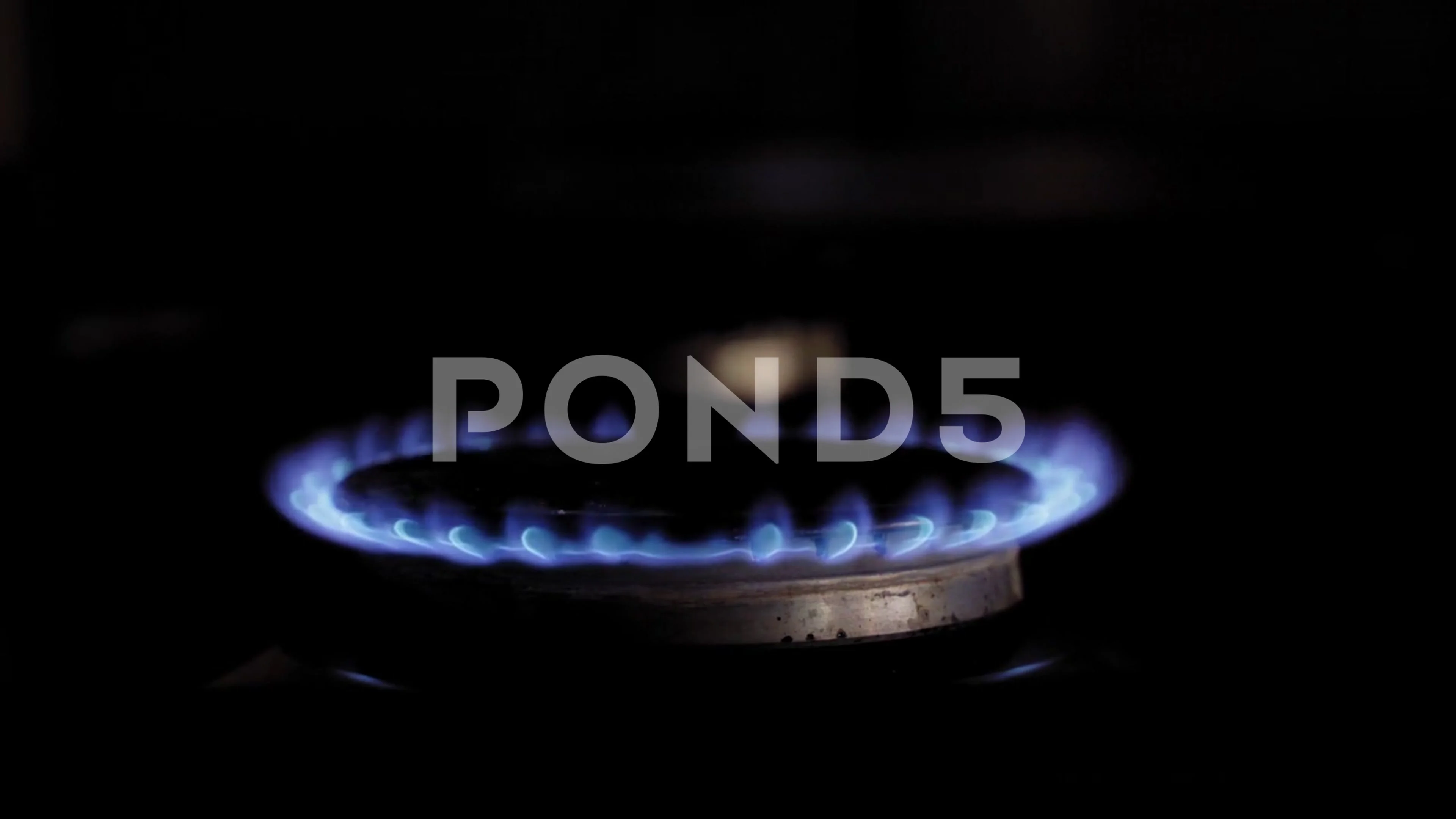 Gas ignites, dark  stove b... | Stock Video | Pond5