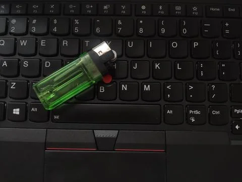 Gas lighter placed on the keyboard, study or work while smoking Foto stock