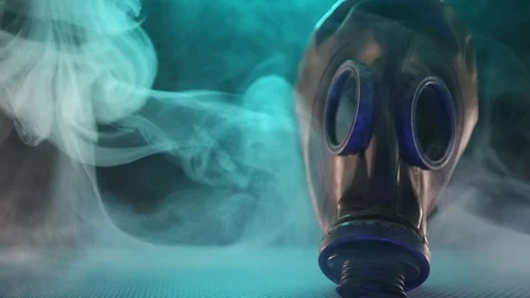 Gas mask with clouds of smoke on a dark background. Stock Footage 124928009