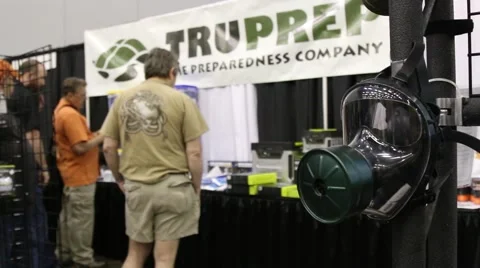 Gas Mask in Foreground of Prepper Display at Doomsday Prepper Convention 스톡 동영상 64906915