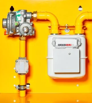 Gas meter with reducer on a yellow background. Stock Photos