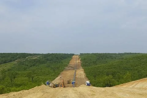 Gas pipeline thread being built in a hilly forest area. Fotos Stock