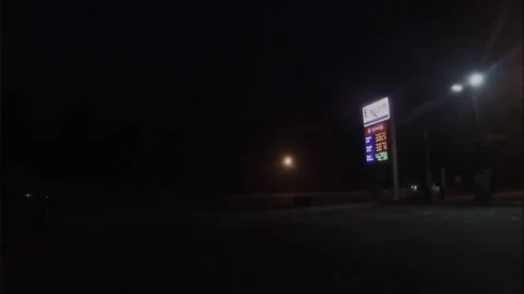 Gas price street sign at Exxon gas station 3.82 a gallon over Ukraine Russian Stock Footage