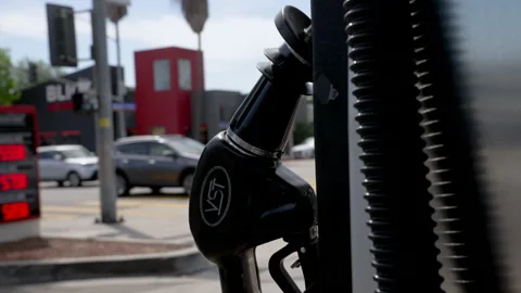 Gas Pump Handle with Traffic in Background. Cinematic Camera Move around Vidéo 201992679