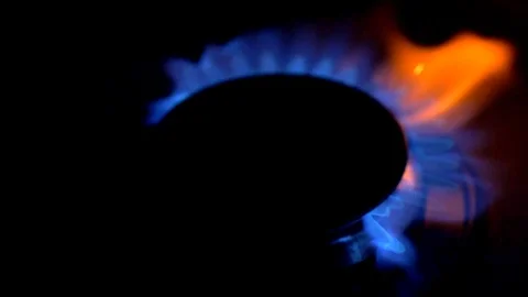 Gas-ring stove with blue flame on black background. Slow motion shot. Stock Footage 88354322