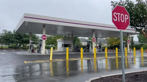 Gas Station Canopy and Stop Sign on Rainy Day with Wet Asphalt Stock Footage 345983315