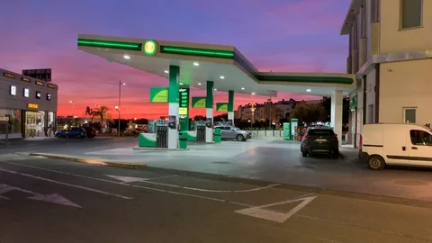 A Gas Station With A Dramatic Red &amp; Purple Sunset In The Background 4K Stock Footage 118966202