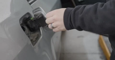 Gas station white caucasian man with wedding ring filling up silver car Stock Footage 233665249