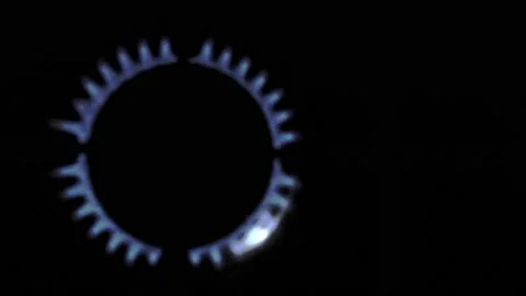 Gas stove being turned on by a lit burner. Natural gas concept. Stock Footage 223872079