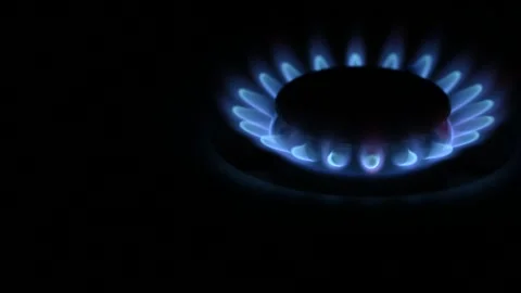 Gas stove burning, on dark background, space for text, close-up. Stock Footage 241004665