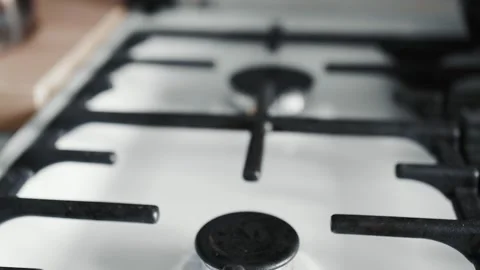 Gas stove with burning fire. Making coffee in copper cezve over gas stove. Stock Footage 152845673