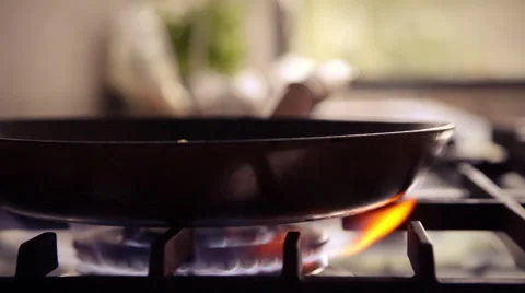 Gas stove wok burner ignited + baking pan utilized in modern design kitchen Stock Footage